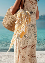 Harmonious - BezzazanHarmonious Bezzazan designer Turkish beach towels for luxury minimalist lifestyle, in straw bag held by beach model in hat