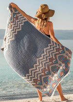 Affectionate Bezzazan soft lightweight unique Turkish beach towel, light blue modern boho tribal design held by boho girl in hat