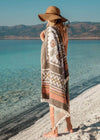 Adventurous Bezzazan Turkish Towel used as a swimsuit cover at the beach on blonde boho girl, wearing a beach boho hat
