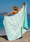 boho girl on beach in boho hat holding Trendy Oversized Turkish towel with fringe and tribal design - Mystical Bezzazan