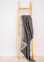 luxury Turkish towel throw blanket for sofa  by Bezzazan, with fringe used as a modern boho decor throw on ladder