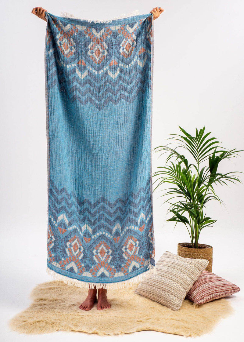 Affectionate Bezzazan luxury Turkish Towel, blue tribal boho chic white fringe, modern minimalist house design, studio shot