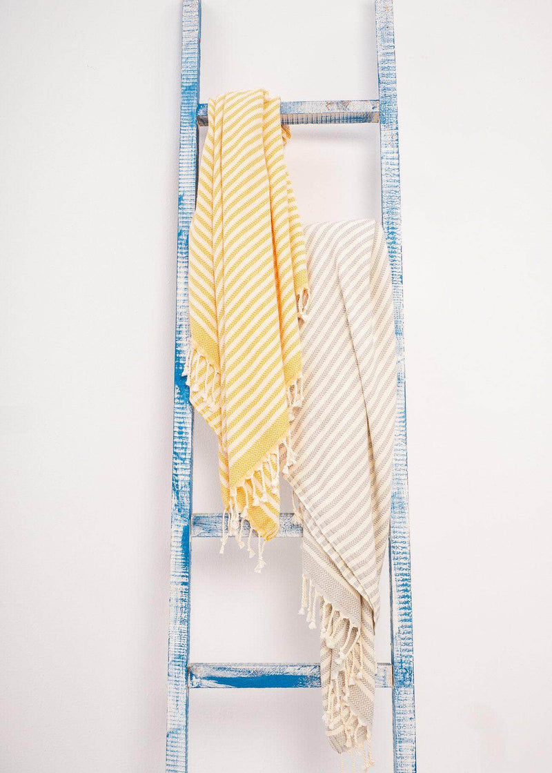 Harmonious premium Turkish towels with stripes by Bezzazan, used as decorative throw blanket for modern home on wooden ladder